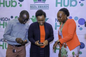 From Right(Baraza Lab CEO Maurice Otieno, Aga Khan CEO Susan Otieno and CIheb CEO Dr Emily Koech use their phones to nominate NGOs during the launch of the NGOs Awards yesterday. Leaders called for diversification in funding for NGOs