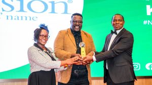 Hon. Nderitu Mureithi hands over the NGO of the year award to Compassion International.